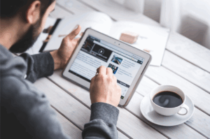 Healthcare professional browsing news and articles on tablet – featured News dropdown image for Staff Relief Inc.